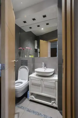 a bathroom with a white toilet and a sink at Apartment Angelo in Belgrade