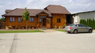 a car parked in front of a wooden house at La dolce vita in Inđija