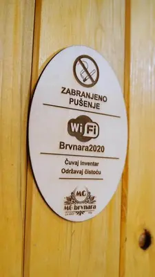 a plaque on a wooden door with a sign on it at La dolce vita in Inđija