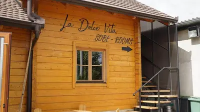 a house with a sign on the side of it at La dolce vita in Inđija