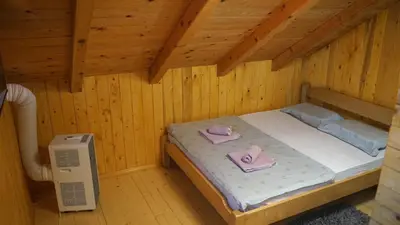a small room with a bed in a wooden cabin at La dolce vita in Inđija