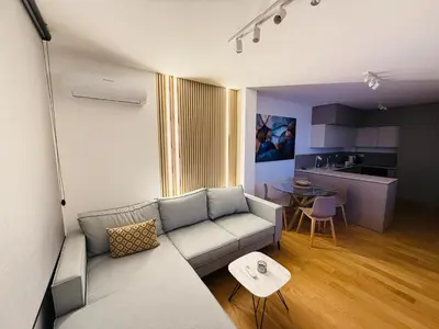 a living room with a couch and a table at GueZt Dobanovačka 93A in Belgrade