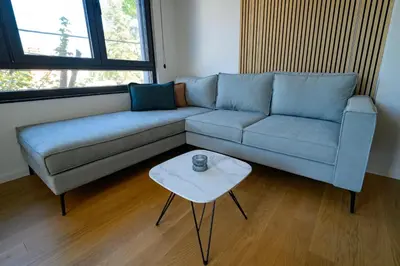 a living room with a blue couch and a table at GueZt Dobanovačka 93A in Belgrade