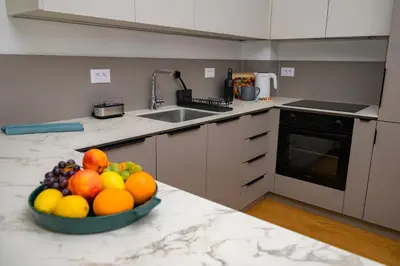 a bowl of fruit on a counter in a kitchen at GueZt Dobanovačka 93A in Belgrade