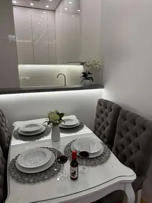 a table with two plates and wine glasses on it at Apartman Mojsilović in Ub