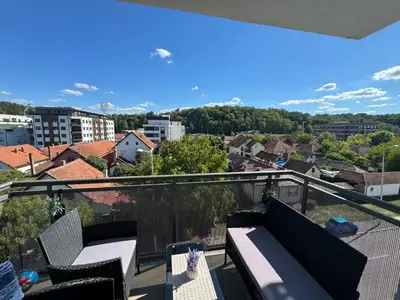 a balcony with chairs and a view of a city at Apartman Mojsilović in Ub
