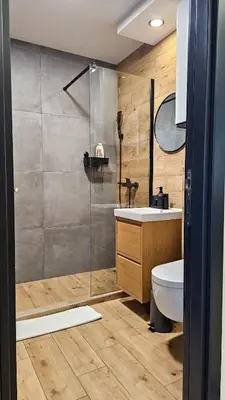 a bathroom with a shower and a toilet and a sink at Sunny Danube Quay Luxe Studio in Belgrade