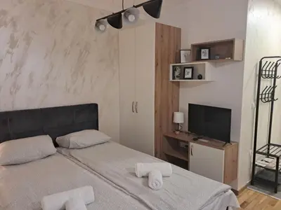 a bedroom with a bed with towels on it at TaMiLux apartments in Belgrade