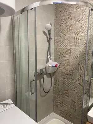 a shower in a bathroom with a glass door at TaMiLux apartments in Belgrade