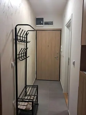 a room with a hallway with a door and a shelf at TaMiLux apartments in Belgrade