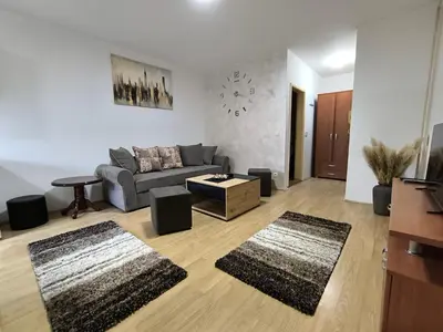 a living room with a couch and a table at R & P Apartman 2 Mladenovac in Mladenovac