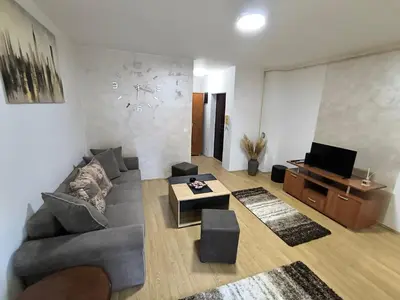 a living room with a couch and a tv at R & P Apartman 2 Mladenovac in Mladenovac