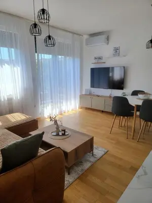 a living room with a couch and a table at Park residence Apartman 2, Mirijevo, Serbia in Belgrade