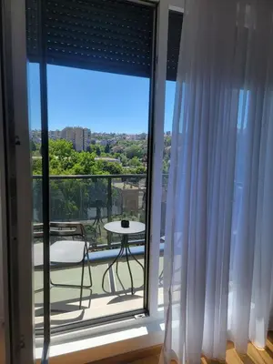 a large window with a view of a balcony at Park residence Apartman 2, Mirijevo, Serbia in Belgrade