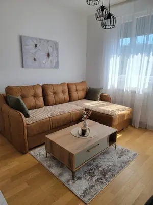 a living room with a brown couch and a coffee table at Park residence Apartman 2, Mirijevo, Serbia in Belgrade