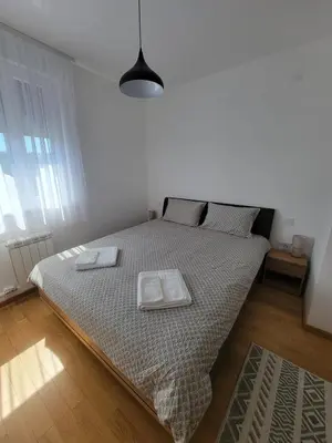 a bedroom with a bed with two plates on it at Park residence Apartman 2, Mirijevo, Serbia in Belgrade