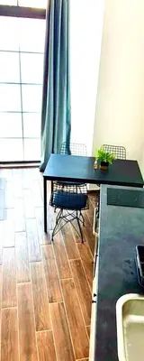 a kitchen with a table and chairs and a sink at Amar 1 in Belgrade
