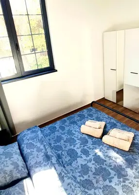 a bedroom with a bed with towels on it at Amar 1 in Belgrade