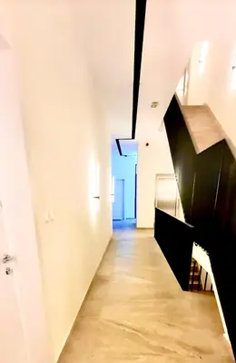 a hallway with a black staircase in a white room at Amar 2 in Belgrade
