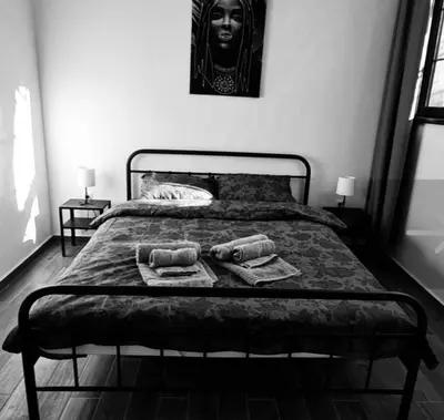 a black and white photo of a bed with two towels at Amar 1 in Belgrade