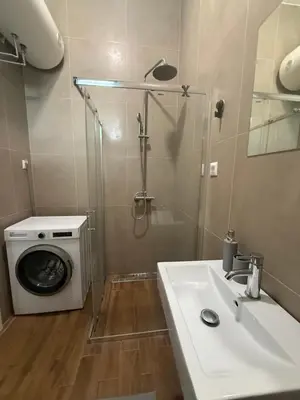 a bathroom with a washing machine and a sink at Amar3 in Belgrade