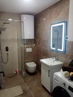 a bathroom with a shower and a toilet and a sink at Apartman P&N Stara Pazova in Stara Pazova