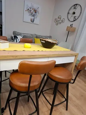 a kitchen with a table with brown leather chairs at Lemon Place in Belgrade