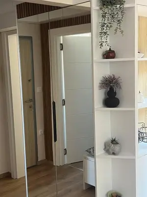 a large mirror in a room with a door at Lemon Place in Belgrade