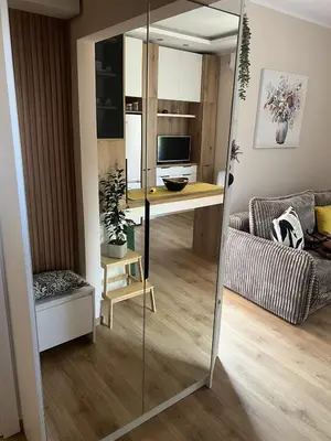a living room with a mirror and a table at Lemon Place in Belgrade