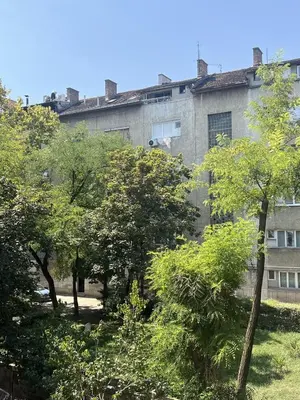 an old building with trees in front of it at Lemon Place in Belgrade