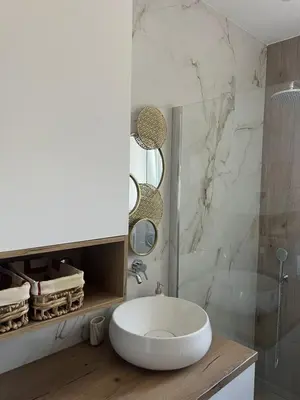 a bathroom with a white sink and a shower at Lemon Place in Belgrade