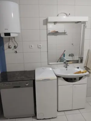 a white kitchen with a sink and a sink at Sunny Villa in Belgrade