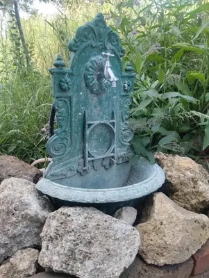a green statue sitting on some rocks at Sunny Villa in Belgrade