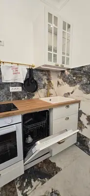 a kitchen with white cabinets and a sink at Admiral Suite in Belgrade