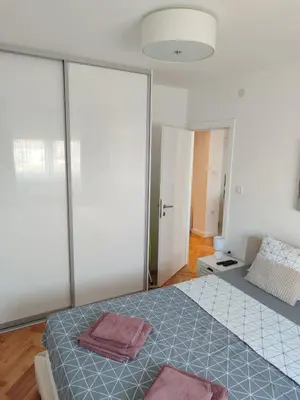a bedroom with a bed with two towels on it at New Belgrade Cozy Base in Belgrade