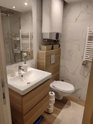 a bathroom with a white sink and a toilet at New Belgrade Cozy Base in Belgrade