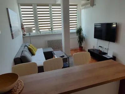 a living room with a couch and a table at New Belgrade Cozy Base in Belgrade