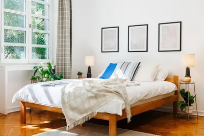 a bedroom with a bed with white sheets and pillows at Chill Flow 110m2 with Balcony Old Town Renovated in Belgrade