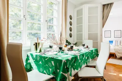 a dining room table with a green table cloth at Chill Flow 110m2 with Balcony Old Town Renovated in Belgrade