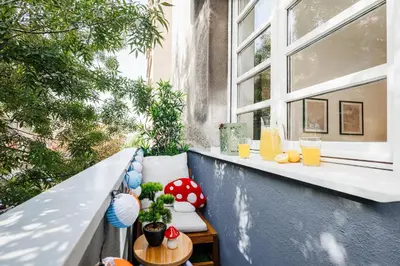 a balcony with a table and two windows at Chill Flow 110m2 with Balcony Old Town Renovated in Belgrade