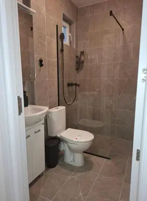 a bathroom with a toilet and a shower and a sink at Burence -m in Železnik
