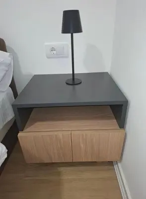 a table with a lamp on top of a wooden drawer at Burence -m in Železnik