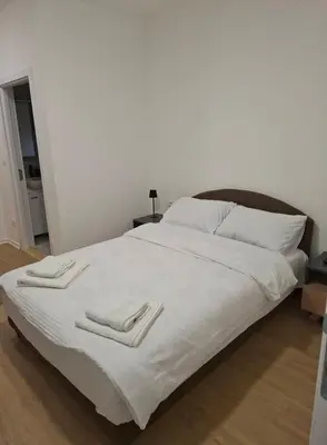 a large white bed with two towels on it at Burence -m in Železnik