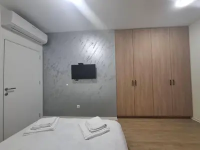 a bedroom with a bed and a tv on a wall at Burence -m in Železnik