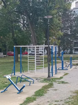 a park with blue gates and a street light at Apartman KEJ Smederevo in Smederevo