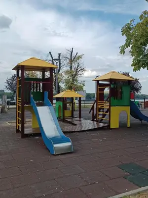 a playground with a slide and a play structure at Apartman KEJ Smederevo in Smederevo