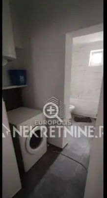 a bathroom with a white toilet and a window at Sandra Brend in Beograd
