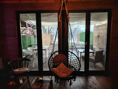 a room with a porch with a swing at Zmajevo Gnezdo II Water House in Beograd