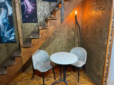 a table and two chairs in front of a staircase at Zmajevo Gnezdo II Water House in Beograd
