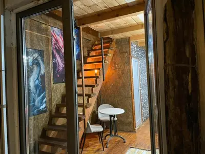 a staircase in a tiny house with a table at Zmajevo Gnezdo II Water House in Beograd